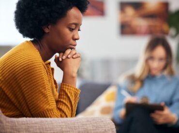 Client receiving holistic psychotherapy Wisconsin support during in-person counseling session