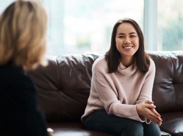 Professional woman reflecting on burnout in high achievers during therapy session
