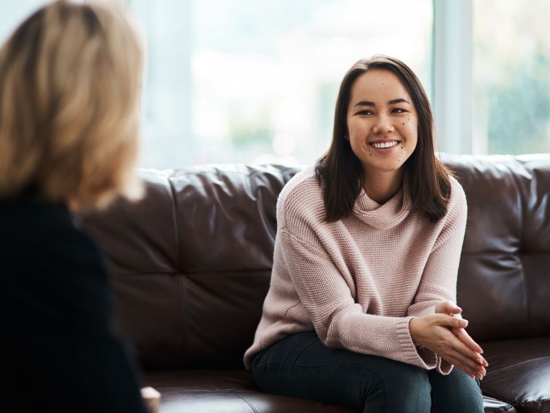 Professional woman reflecting on burnout in high achievers during therapy session