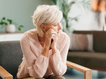 Professional woman reflecting on burnout in high achievers during therapy session