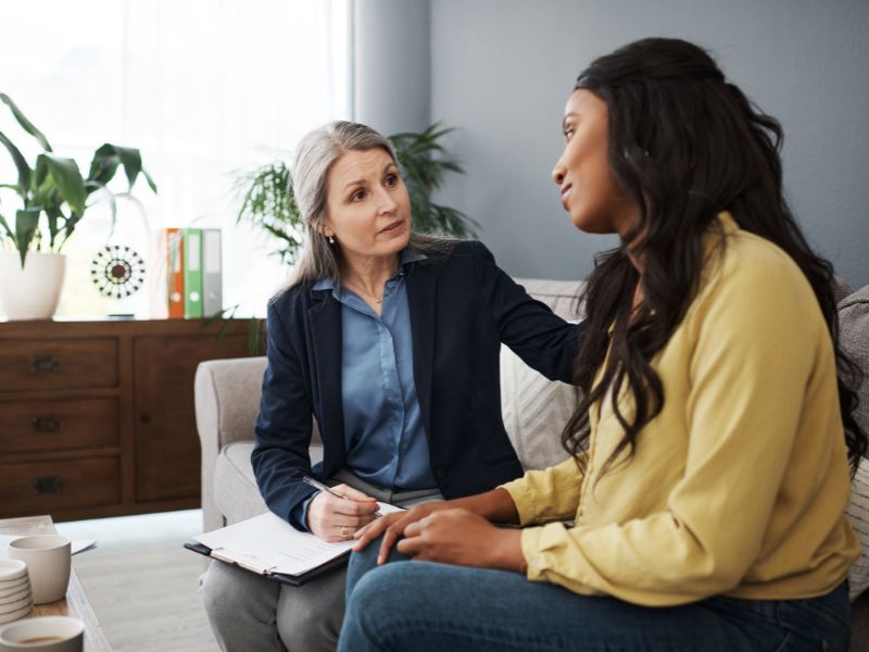Therapist supporting client experiencing anxiety and disconnection during counseling session