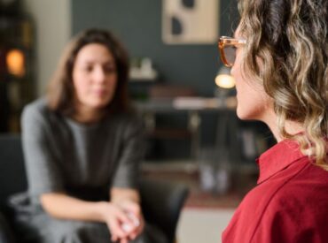 Client and therapist engaged in identity exploration therapy conversation