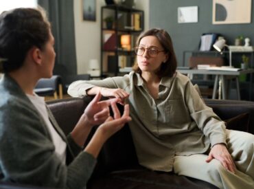 Psychotherapist listening to client discuss symptoms during burnout checklist counseling session