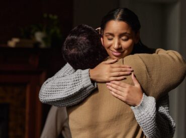 Client embracing loved one after progress in Humanistic therapy in Wisconsin